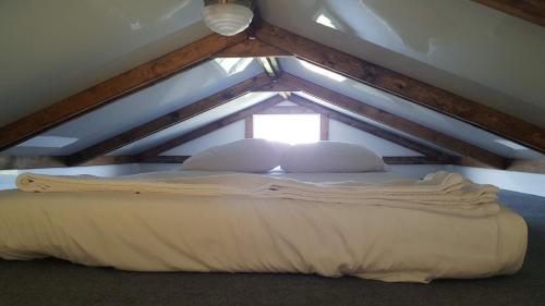 a bed with two pillows in a attic at Old Wooden Bridge Resort & Marina in Big Pine Key