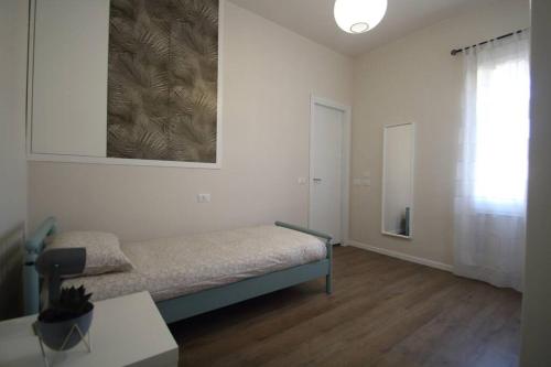 a bedroom with a bed and a table and a window at Casa Ol Gàl in Bergamo