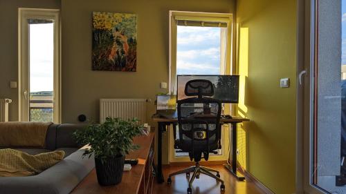 a living room with a couch and a table with a camera at Luxurious villa-apartment with spacious terrace in Prague