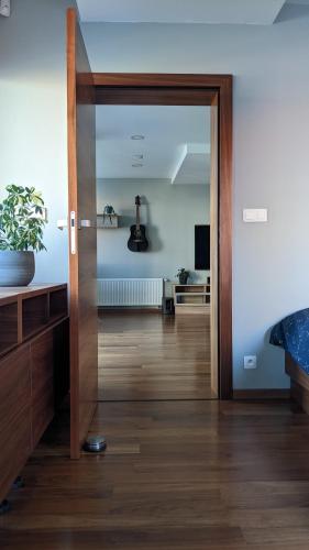a room with a door open to a living room at Luxurious villa-apartment with spacious terrace in Prague
