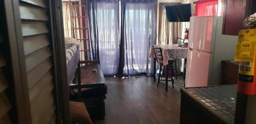 a kitchen with a refrigerator and a table in a room at Old Wooden Bridge Resort & Marina in Big Pine Key