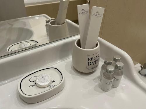 a bathroom counter with toothbrushes and a mirror at Lazurowa Prowansja in Bolesławiec