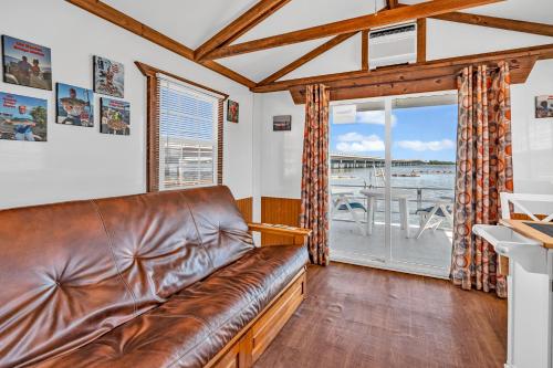 a leather couch in a living room with a large window at Old Wooden Bridge Resort & Marina in Big Pine Key