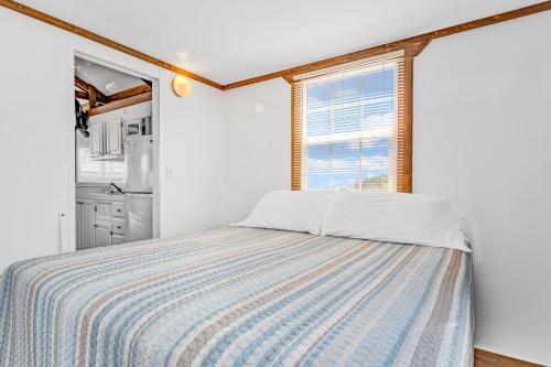 a bedroom with a bed and a window at Old Wooden Bridge Resort & Marina in Big Pine Key