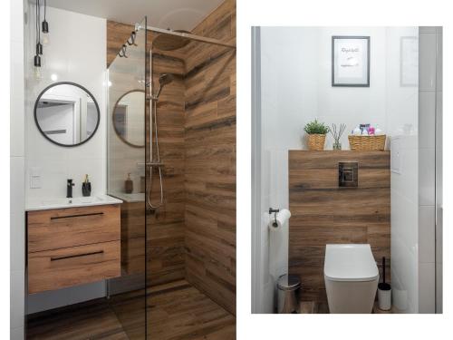 a bathroom with a shower and a toilet and a mirror at MGM HOME Wawer Międzylesie Centrum Zdrowia Dziecka in Warsaw