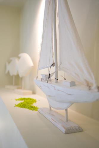 a toy sailboat on a table in a room at Isalos in Vasiliki