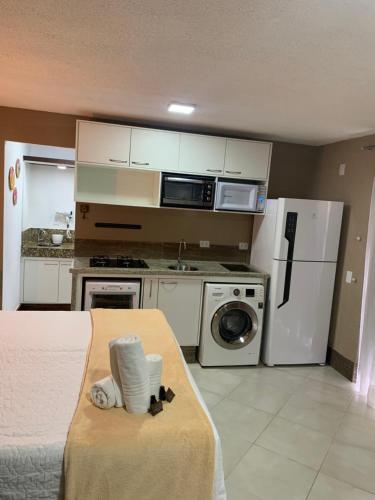 a small kitchen with a bed in a room at Pousada Reserva Penedo in Penedo