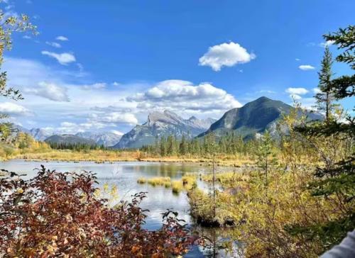 a view of a river with mountains in the background at Falcon Crest Lodge 1 BR Condo With Gym & Hot-Tubs & Mountain View in Canmore