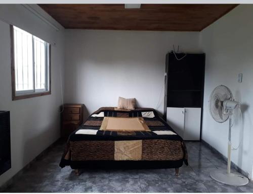 a bedroom with a bed in the corner of a room at WENDY Ranch in Falda del Carmen