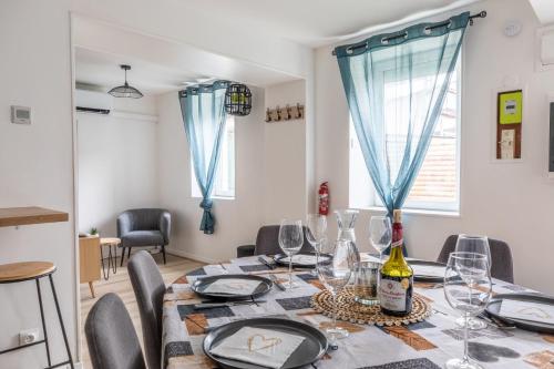 a dining room with a table with wine glasses at Maison de campagne & SPA, Barbecue, Clim, WIFI 