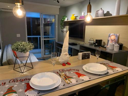 a table with plates and glasses on top of it at Modernidade e conforto para sua hospedagem !!! in Sao Paulo