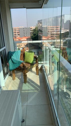a bench on a balcony with a view of a city at Modernidade e conforto para sua hospedagem !!! in Sao Paulo