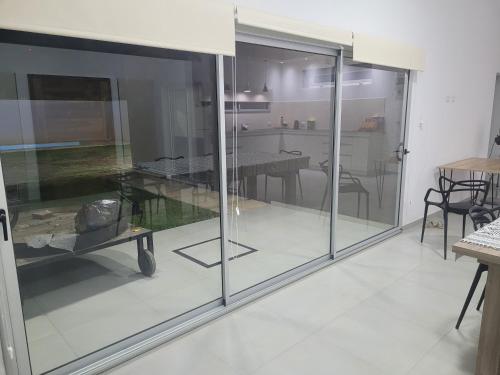 a living room with glass doors and a table at La cabala in General Alvear