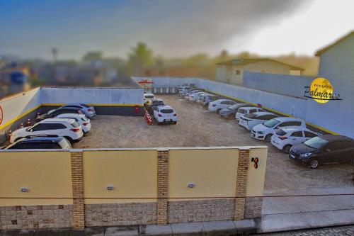 a bunch of cars parked in a parking lot at Pousada Palmares in Cabo Frio