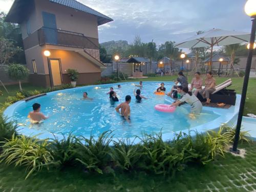 a group of people playing in a swimming pool at ZEN garden in Xuyên Mộc