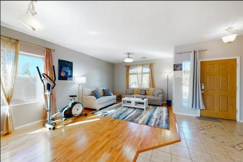 a living room with a couch and a table at NEW! Stunning Peaceful Peoria Home - Very Close to Sports Complex in Peoria