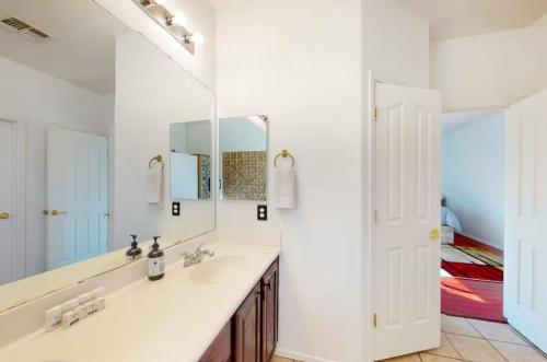 a bathroom with a sink and a mirror at NEW! Stunning Peaceful Peoria Home - Very Close to Sports Complex in Peoria