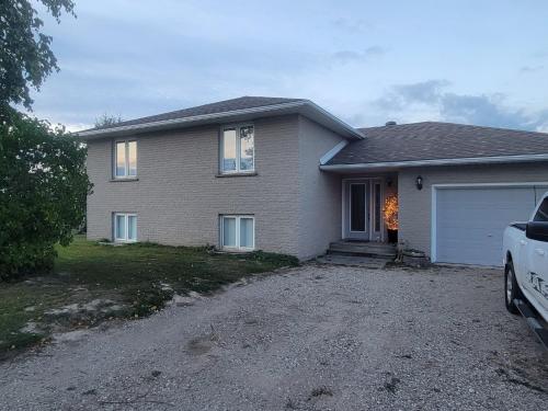 a house with a car parked in front of it at Saugeen Shores Vacation Rental in Port Elgin