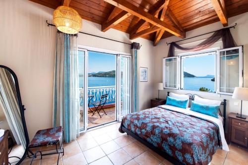 a bedroom with a bed and a view of the ocean at Villa Thalassa Desimi by Villa Plus in Katokhórion