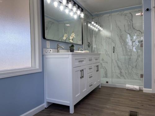 a white bathroom with a sink and a shower at Temecula Rejuvenation in Temecula