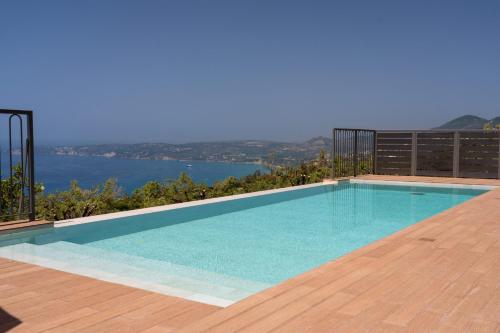 a swimming pool with a view of the water at Villa Katoikia Dio by Villa Plus in Simotáta