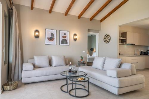 a living room with a couch and a table at Villa Katoikia Dio by Villa Plus in Simotáta
