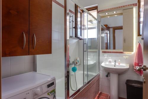 a bathroom with a shower and a sink at Villa Irines House by Villa Plus in Khromonastírion