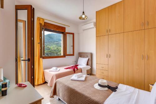 a small room with two beds and a window at Villa Irines House by Villa Plus in Khromonastírion