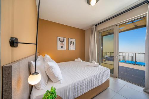 A bed or beds in a room at Villa Katoikia Mia by Villa Plus