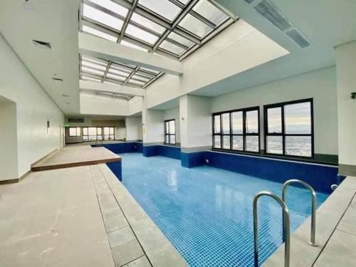 an empty swimming pool with a large ceiling at Eastwood High Life - Spectacular City View in Manila