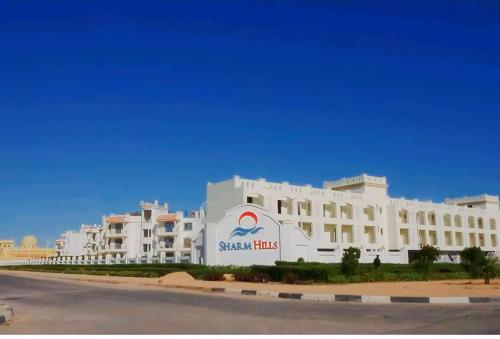 a large white building with a sign on it at Sharm Hills Resort in Sharm El Sheikh