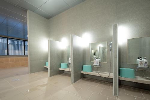 a public bathroom with two sinks and two stalls at Chestertons Sokcho in Sokcho