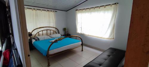 a small bedroom with a bed and a window at Villa Sarita Zona Rural de Melgar a 28 Minutos del Casco Urbano in Melgar