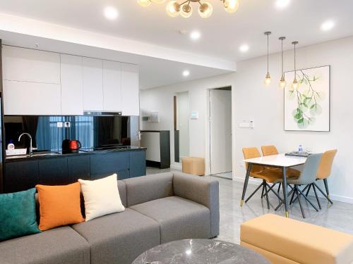 a living room and kitchen with a couch and a table at TSQ STAY Hotel Apartment in Hanoi