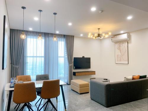 a living room with a couch and a table at TSQ STAY Hotel Apartment in Hanoi