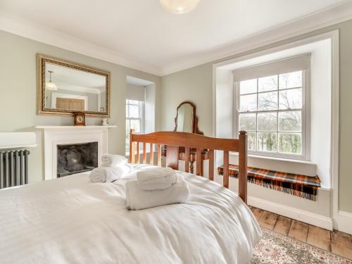 Un pat sau paturi într-o cameră la Maclaren House