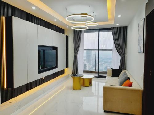 a living room with a tv and a couch at TSQ STAY Hotel Apartment in Hanoi