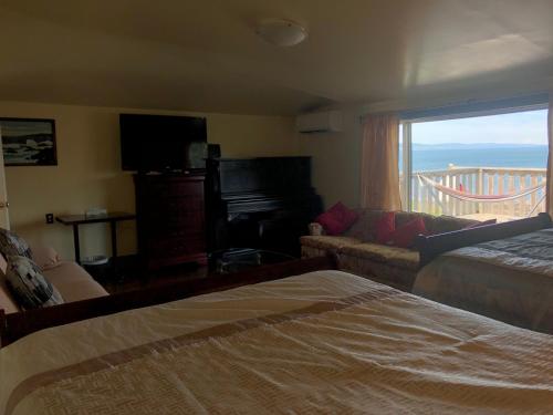 a bedroom with a bed and a couch and a window at 78 Montague in Digby