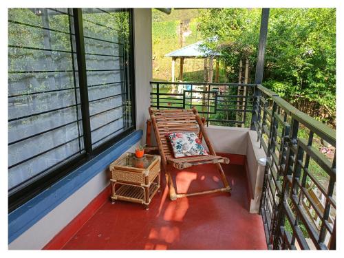 a porch with a rocking chair on a balcony at Sha Ri Loum Homestay in Shillong