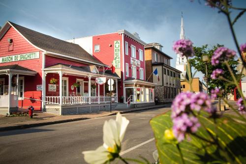 a street in a small town with colorful buildings at Auberge de la Vieille Maison in Rimouski