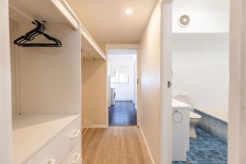 a small bathroom with a toilet and a sink at Galoola Hidden Gem, 2 97 Galoola Drive, Pet friendly, Rooftop outdoor area with spectacular views, Wi-Fi and air conditioning in Nelson Bay
