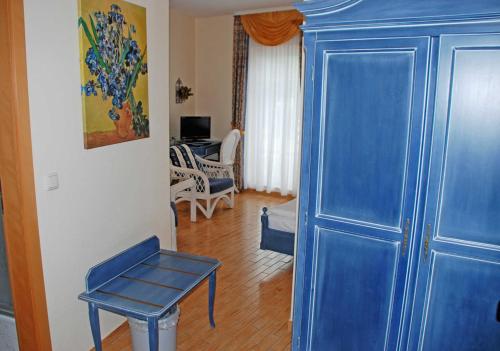 a blue door in a room with a table and a chair at DEB 021 Hotel in Juliusruh auf Rue in Juliusruh