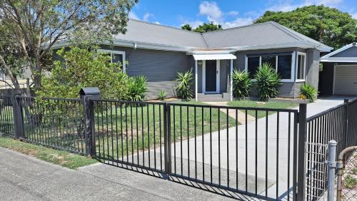 a fence in front of a house at 9 Breckenridge Street in Forster