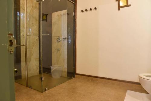 a shower with a glass door in a bathroom at Blackberry Hills Munnar Nature Resort & Spa in Munnar