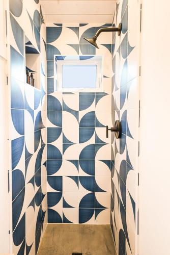 a hallway with blue and white patterned walls at Shortboard Room includes Queen Bed in Stinson Beach