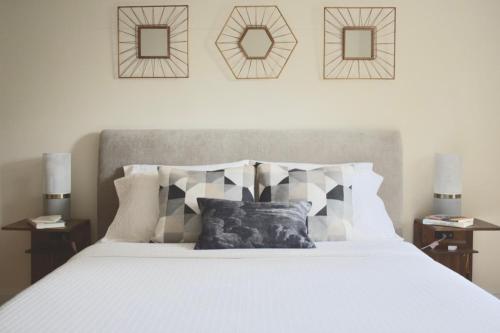 una camera da letto con un grande letto bianco con due comodini di Family Friendly Montclair Hideaway a Montclair
