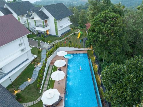 an aerial view of a swimming pool with umbrellas at Sprise Munnar Resort and Spa in Munnar