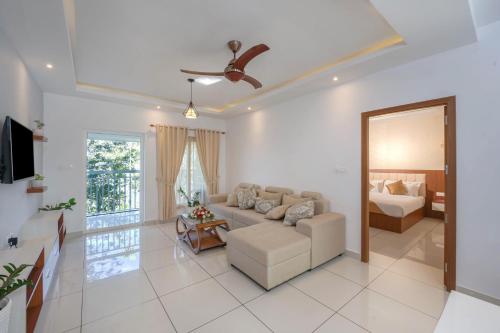 a living room with a couch and a bed at Sprise Munnar Resort and Spa in Munnar