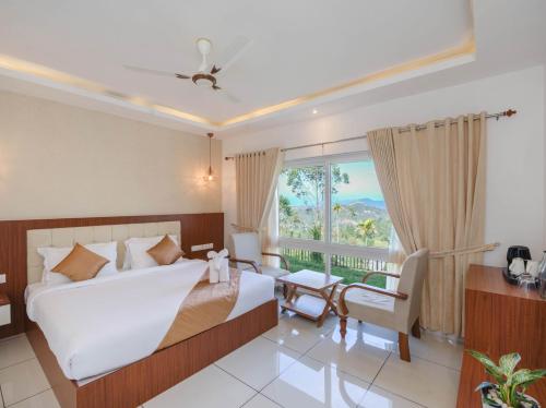 a hotel room with a bed and a window at Sprise Munnar Resort and Spa in Munnar