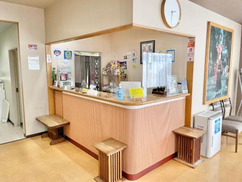 a restaurant with a counter with two benches in a room at Miyazaki Five Seas Hotel - Vacation STAY 09454v in Miyazaki